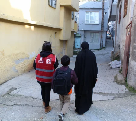 ASAM field worker accompanying Omar and his mother to school